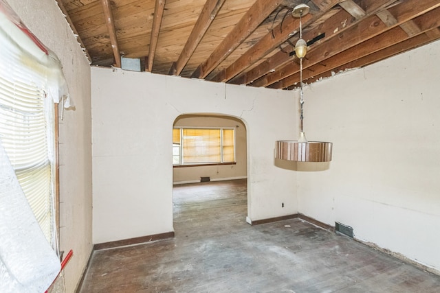 907 W Beardsley Ave, Champaign, IL 61821 - spare room featuring unfinished concrete floors and arched walkways