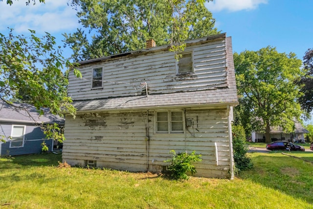 907 W Beardsley Ave, Champaign, IL 61821 - rear view of house with a chimney and a lawn