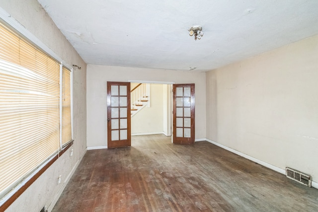 907 W Beardsley Ave, Champaign, IL 61821 - unfurnished room featuring french doors, wood finished floors, and stairway
