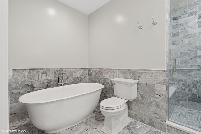 369 W Superior St Unit A, Chicago, IL 60654 - bathroom with a freestanding bath, wainscoting, a shower stall, tile walls, and marble finish flooring