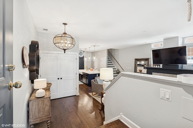 369 W Superior St Unit A, Chicago, IL 60654 - entryway with a chandelier, dark wood-style floors, and stairs