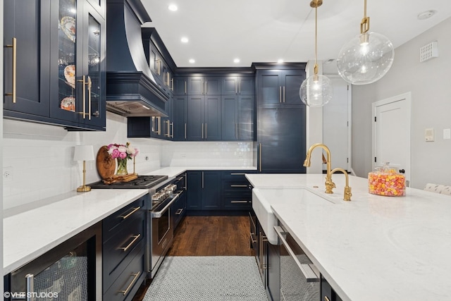 369 W Superior St Unit A, Chicago, IL 60654 - kitchen with wine cooler, high end stove, custom exhaust hood, light stone countertops, and hanging light fixtures
