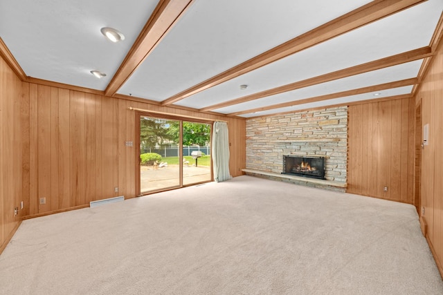 212 Forsythe Ln, Dekalb, IL 60115 - unfurnished living room with beam ceiling, wood walls, a fireplace, and carpet