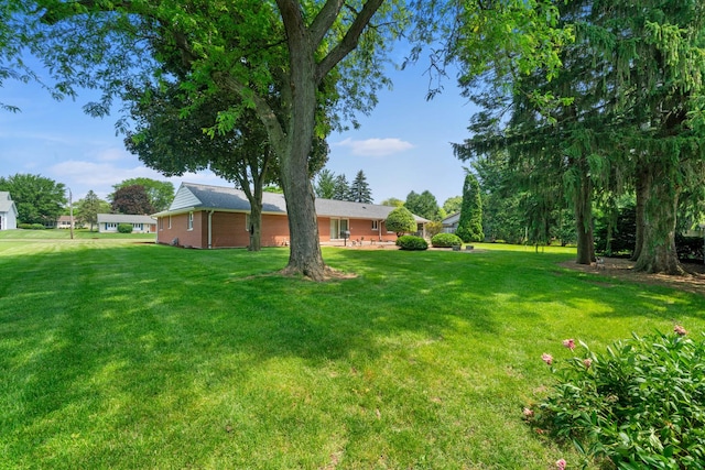 212 Forsythe Ln, Dekalb, IL 60115 - view of green lawn featuring a patio area