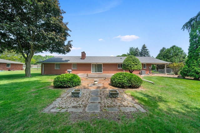 212 Forsythe Ln, Dekalb, IL 60115 - rear view of house with brick siding, a lawn, a chimney, and a patio