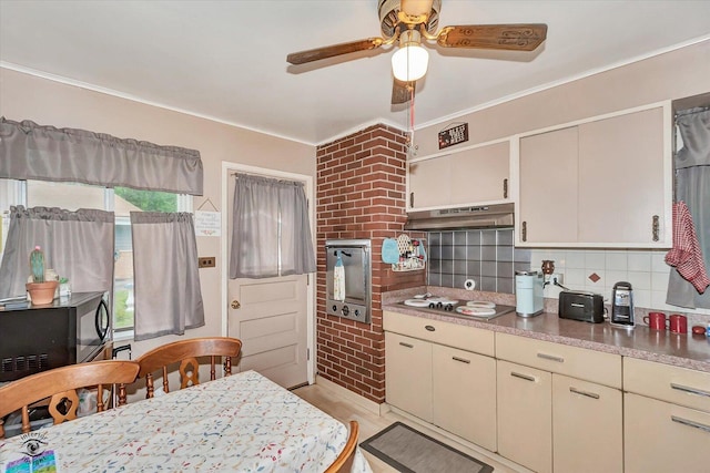 109 Wilson St, Park Forest, IL 60466 - kitchen featuring under cabinet range hood, cooktop, a ceiling fan, backsplash, and light wood-style floors