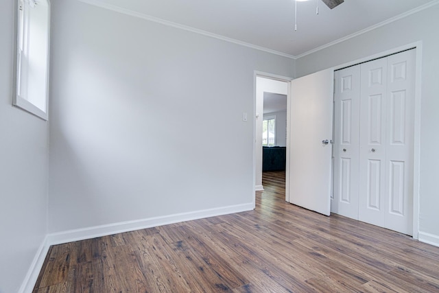 336 Manitowac St, Park Forest, IL 60466 - unfurnished bedroom with wood finished floors, ornamental molding, a closet, and ceiling fan
