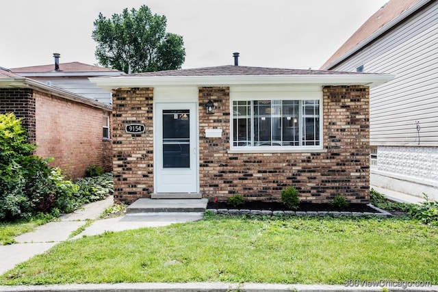 9154 S Luella Ave, Chicago, IL 60617 - view of front of house featuring brick siding and a front lawn