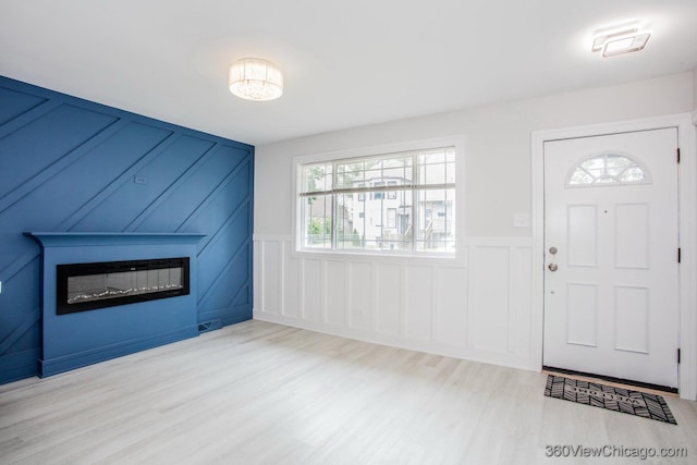9154 S Luella Ave, Chicago, IL 60617 - foyer entrance featuring a decorative wall, a large fireplace, wood finished floors, and wainscoting