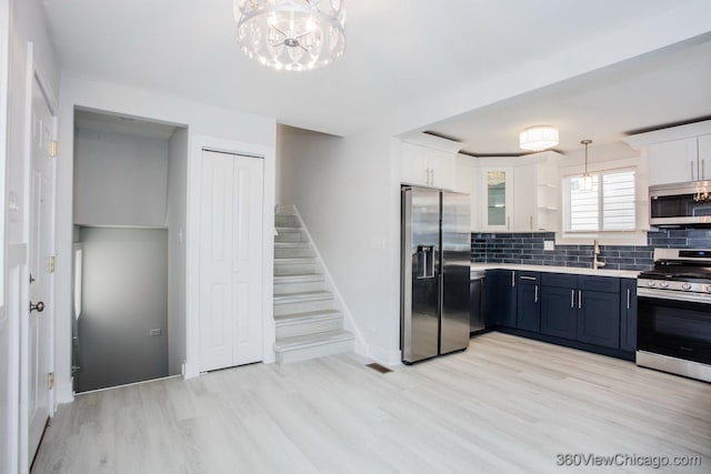 9154 S Luella Ave, Chicago, IL 60617 - kitchen with stainless steel appliances, tasteful backsplash, white cabinets, light wood finished floors, and light countertops