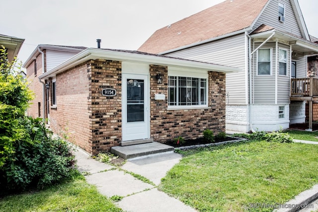 9154 S Luella Ave, Chicago, IL 60617 - view of front facade featuring a front yard and brick siding