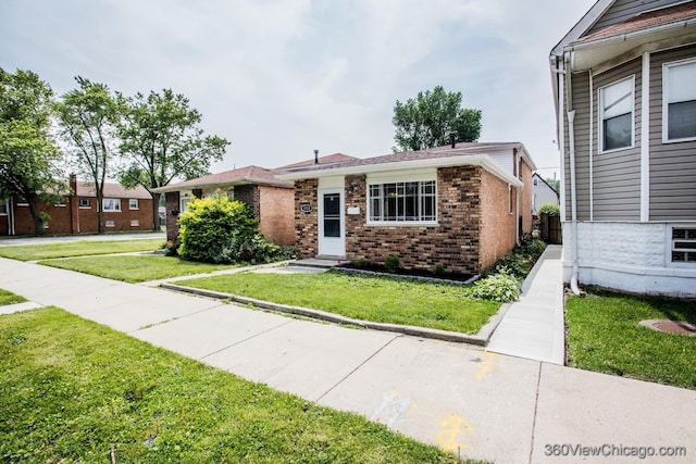 9154 S Luella Ave, Chicago, IL 60617 - view of front of home featuring brick siding and a front lawn