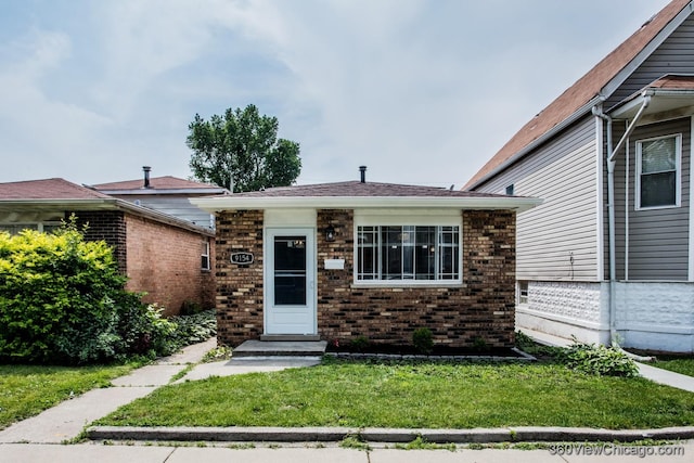 9154 S Luella Ave, Chicago, IL 60617 - view of front of home with brick siding and a front lawn