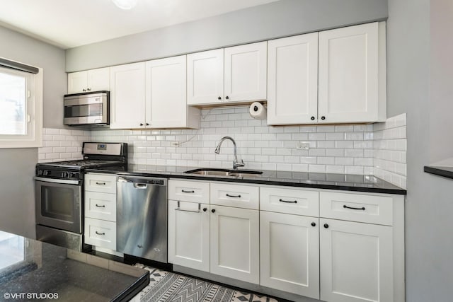 4248 N Keystone Ave Unit 2C, Chicago, IL 60641 - kitchen with appliances with stainless steel finishes, white cabinetry, backsplash, and dark stone counters