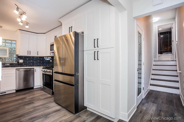 9206 S Yates Blvd, Chicago, IL 60617 - kitchen featuring appliances with stainless steel finishes, dark wood finished floors, white cabinetry, tasteful backsplash, and light countertops
