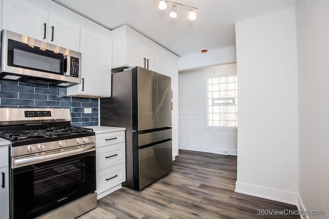 9206 S Yates Blvd, Chicago, IL 60617 - kitchen with stainless steel appliances, light countertops, dark wood-style flooring, decorative backsplash, and white cabinetry