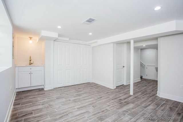 9206 S Yates Blvd, Chicago, IL 60617 - finished below grade area with light wood-style flooring, recessed lighting, wet bar, and stairway