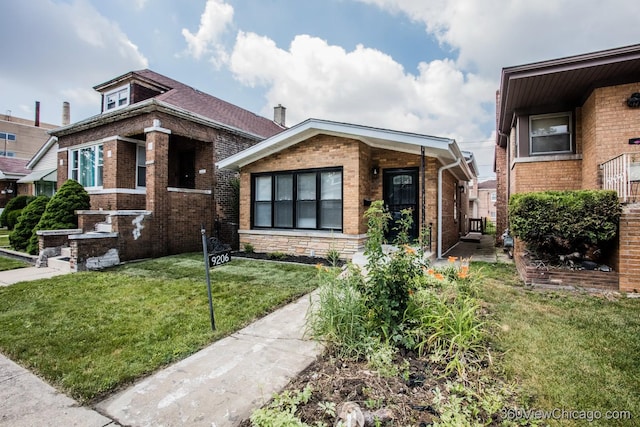 9206 S Yates Blvd, Chicago, IL 60617 - bungalow featuring brick siding and a front lawn