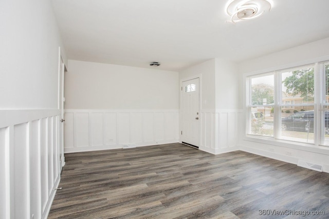 9206 S Yates Blvd, Chicago, IL 60617 - unfurnished room featuring a wainscoted wall and dark wood-style flooring