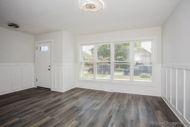 9206 S Yates Blvd, Chicago, IL 60617 - entryway featuring a wainscoted wall, dark wood-style floors, and a decorative wall
