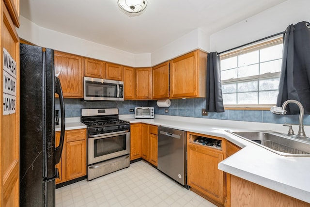 763 Highview Ct, Antioch, IL 60002 - kitchen with appliances with stainless steel finishes, light flooring, light countertops, and brown cabinetry