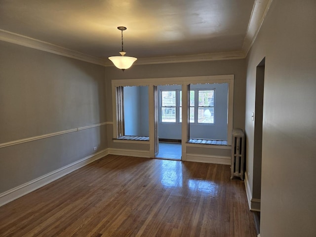 7543 S Yates Blvd, Chicago, IL 60649 - spare room featuring radiator heating unit, crown molding, and dark wood-style flooring