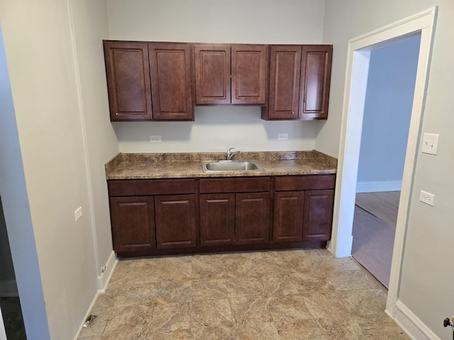 7543 S Yates Blvd, Chicago, IL 60649 - kitchen featuring dark brown cabinetry and dark countertops