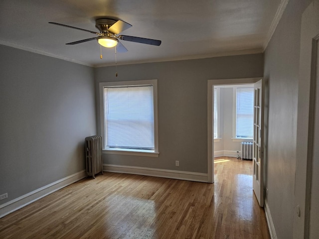 7543 S Yates Blvd, Chicago, IL 60649 - unfurnished room with radiator heating unit, ornamental molding, plenty of natural light, and wood finished floors