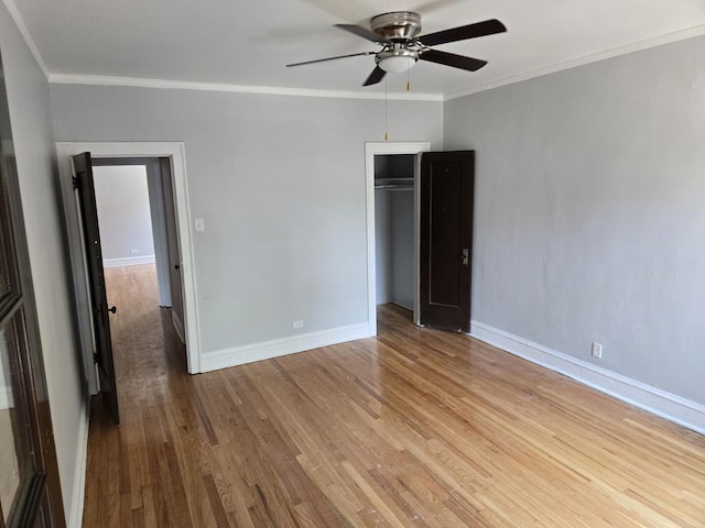 7543 S Yates Blvd, Chicago, IL 60649 - unfurnished bedroom with wood finished floors, crown molding, a closet, and a ceiling fan