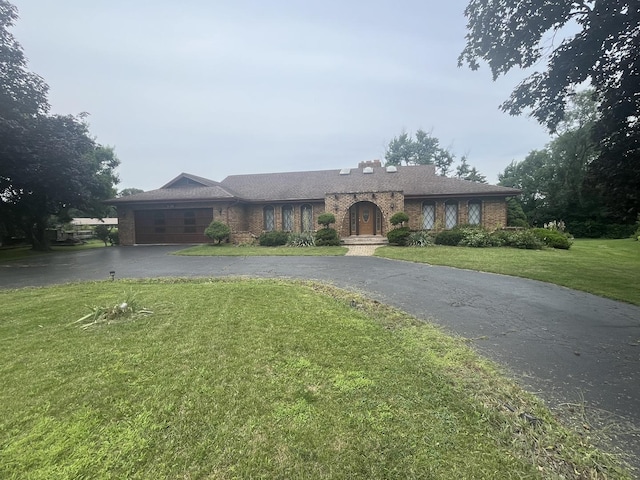 10S220 Hampshire Ln W, Willowbrook, IL 60527 - single story home with asphalt driveway, a garage, brick siding, and a front yard