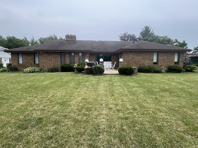10S220 Hampshire Ln W, Willowbrook, IL 60527 - rear view of house featuring brick siding, a patio area, and a yard