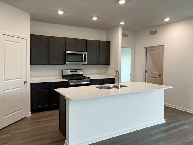 2282 Elderberry Ct, Wonder Lake, IL 60097 - kitchen featuring stainless steel appliances, dark wood-type flooring, light countertops, recessed lighting, and a center island with sink