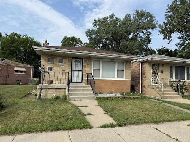 8114 S Anthony Ave, Chicago, IL 60617 - bungalow-style home with brick siding, a chimney, a front lawn, and a porch