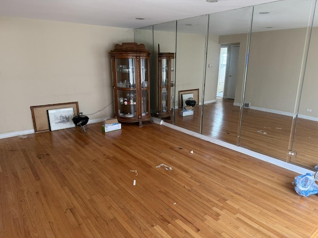 8114 S Anthony Ave, Chicago, IL 60617 - unfurnished living room featuring hardwood / wood-style flooring and baseboards
