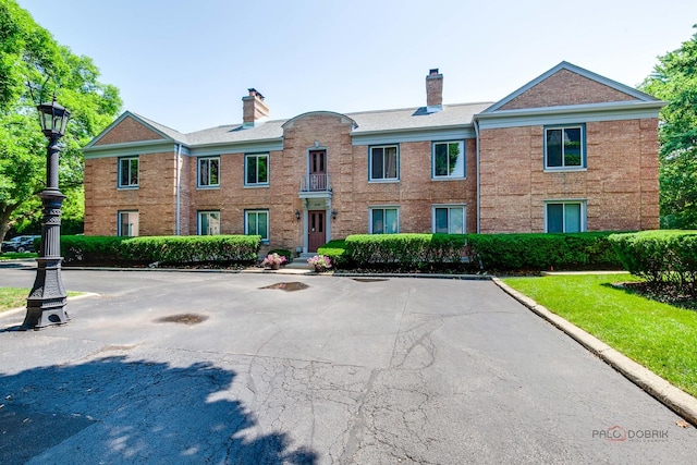 1499 Shermer Rd Unit 204E, Northbrook, IL 60062 - view of front of home featuring a chimney and brick siding