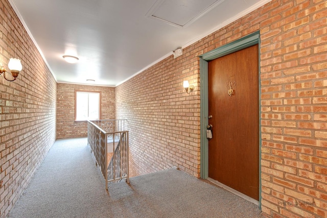 1499 Shermer Rd Unit 204E, Northbrook, IL 60062 - hall featuring brick wall, carpet floors, ornamental molding, and an upstairs landing