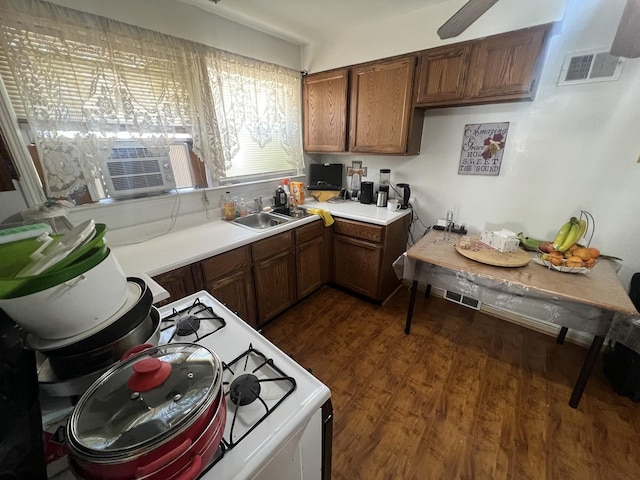 9013 La Crosse Ave, Skokie, IL 60077 - kitchen with white range with gas stovetop, light countertops, dark wood-type flooring, cooling unit, and brown cabinetry
