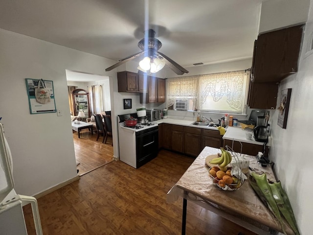 9013 La Crosse Ave, Skokie, IL 60077 - kitchen with gas stove, light countertops, a ceiling fan, dark wood-style floors, and dark brown cabinets
