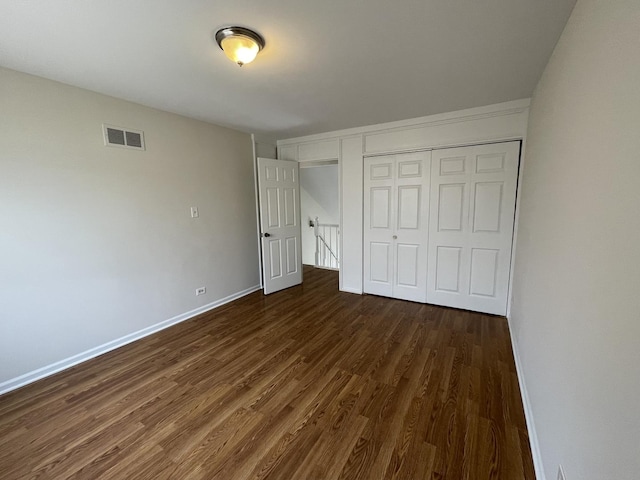 8148 W 111th St Unit C3, Palos Hills, IL 60465 - unfurnished bedroom with dark wood-style flooring and a closet