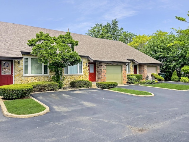 8148 W 111th St Unit C3, Palos Hills, IL 60465 - view of front of property featuring a shingled roof, stone siding, a garage, and driveway