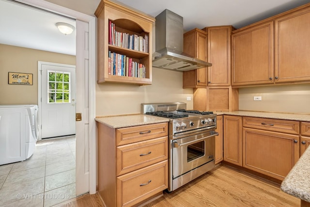 195 Cold Spring Rd, Barrington, IL 60010 - kitchen featuring wall chimney exhaust hood, designer range, independent washer and dryer, light stone countertops, and light wood-style flooring