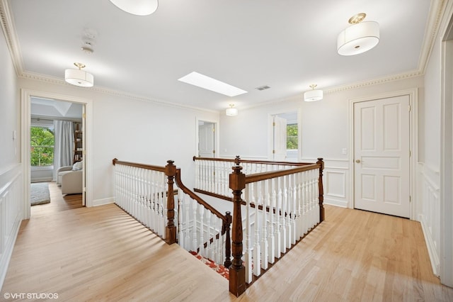 2007 Wilmette Ave, Wilmette, IL 60091 - hallway featuring an upstairs landing, a skylight, plenty of natural light, light wood finished floors, and a decorative wall