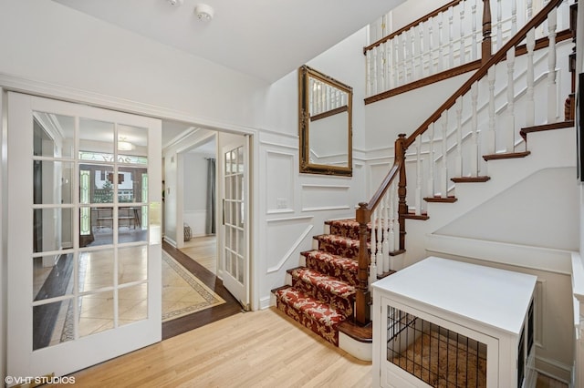2007 Wilmette Ave, Wilmette, IL 60091 - stairway with french doors, wood finished floors, and a decorative wall
