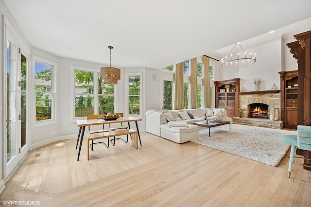 2007 Wilmette Ave, Wilmette, IL 60091 - living area featuring light wood finished floors, a stone fireplace, and a chandelier