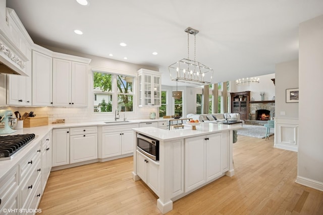 2007 Wilmette Ave, Wilmette, IL 60091 - kitchen featuring stainless steel appliances, open floor plan, light wood-type flooring, a kitchen island, and recessed lighting