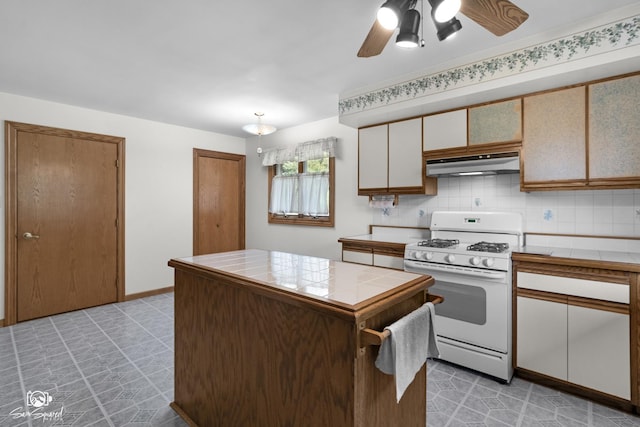 4849 W Kennedy Rd, Peotone, IL 60468 - kitchen featuring tile counters, white range with gas cooktop, ceiling fan, and under cabinet range hood