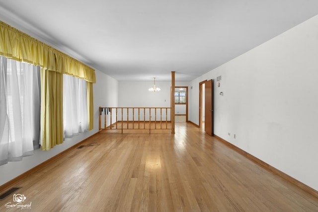 4849 W Kennedy Rd, Peotone, IL 60468 - spare room featuring a chandelier and light wood-style floors