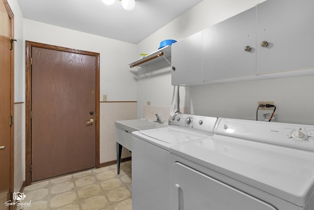 4849 W Kennedy Rd, Peotone, IL 60468 - laundry area with cabinet space, washing machine and clothes dryer, light flooring, tile walls, and wainscoting