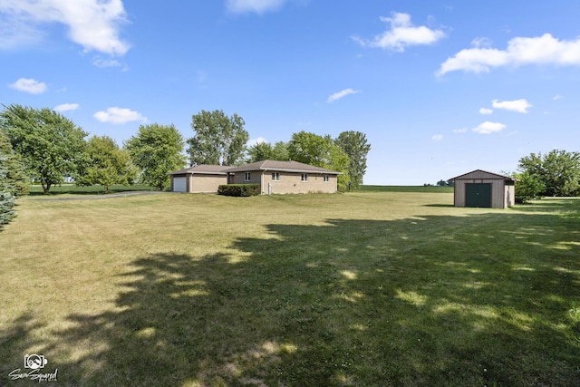 4849 W Kennedy Rd, Peotone, IL 60468 - view of grassy yard featuring a shed and a detached garage