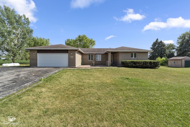 4849 W Kennedy Rd, Peotone, IL 60468 - ranch-style house featuring asphalt driveway, a garage, brick siding, and a front lawn